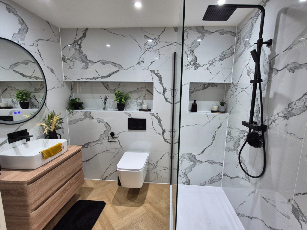 Luxury bathroom transformation in Stamford featuring large format tiles and modern lighting