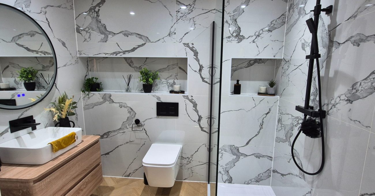 Luxury bathroom transformation in Stamford featuring large format tiles and modern lighting